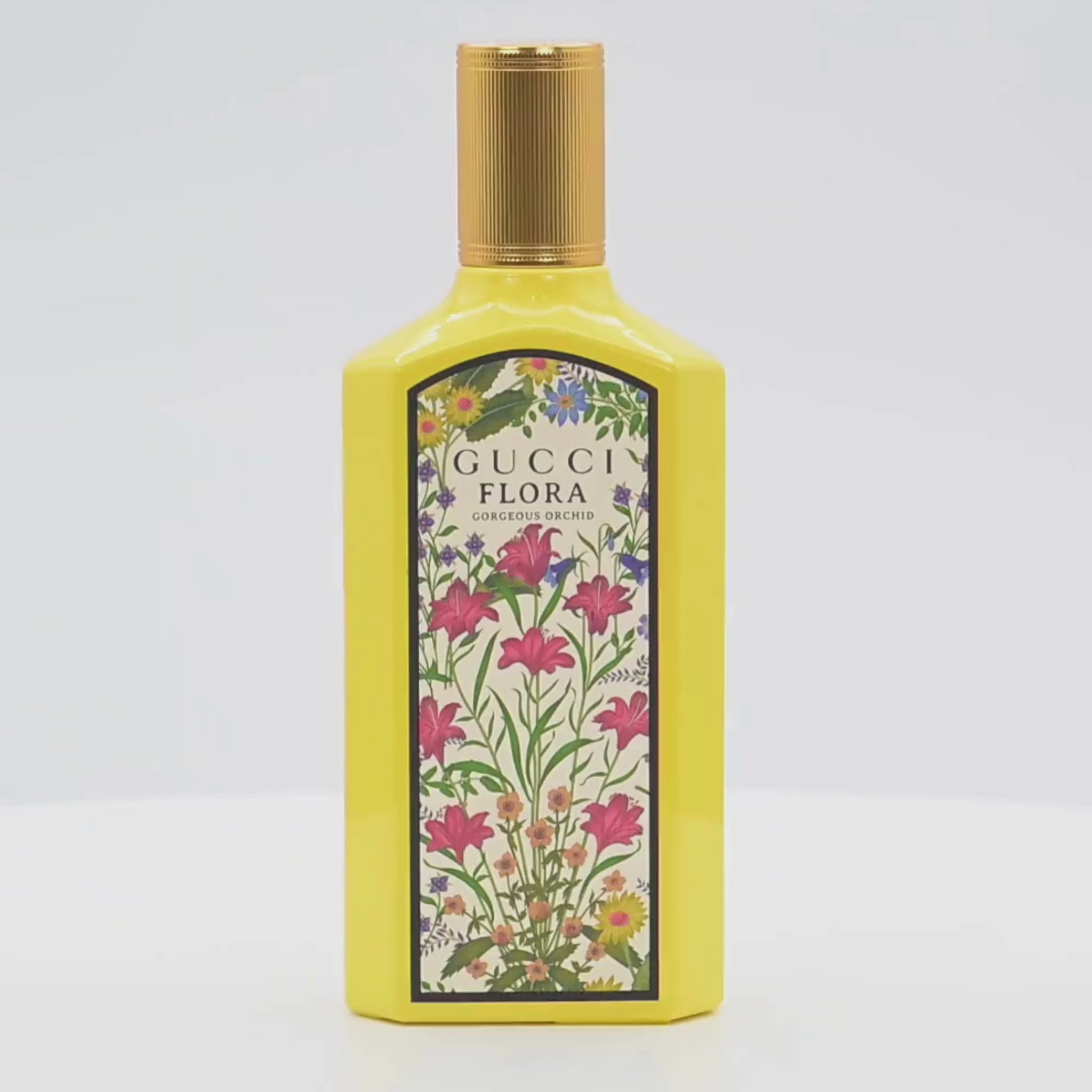 Gucci Flora Orchid perfume bottle rotating on a white podium
