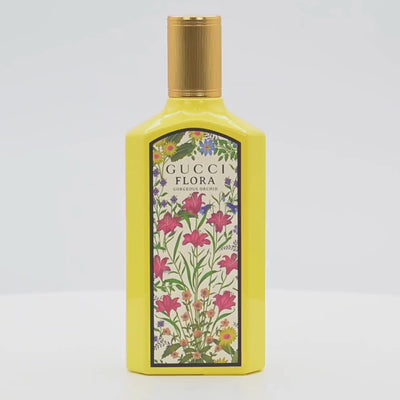 Gucci Flora Orchid perfume bottle rotating on a white podium
