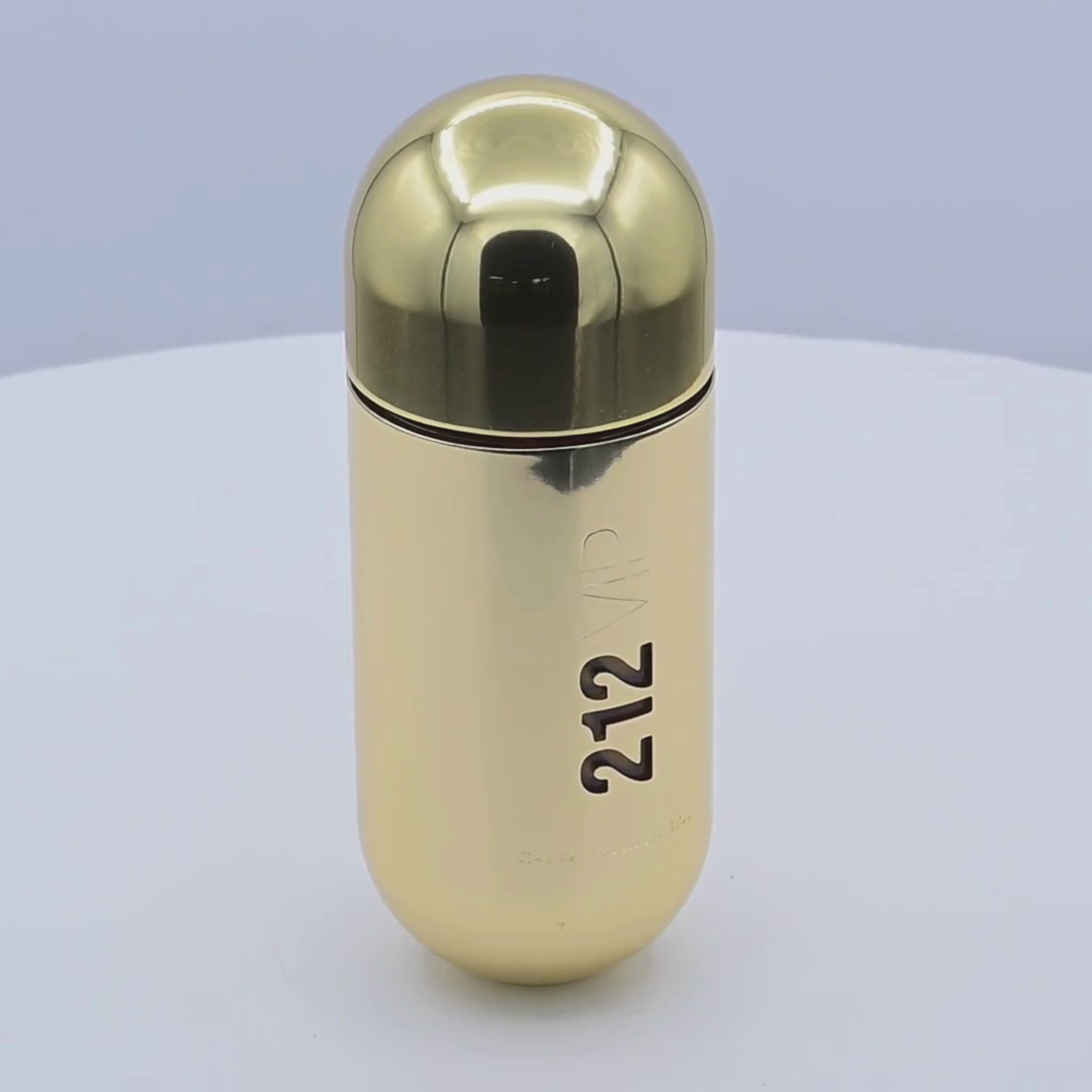 Gold perfume bottle with '212' branding rotating on a white podium