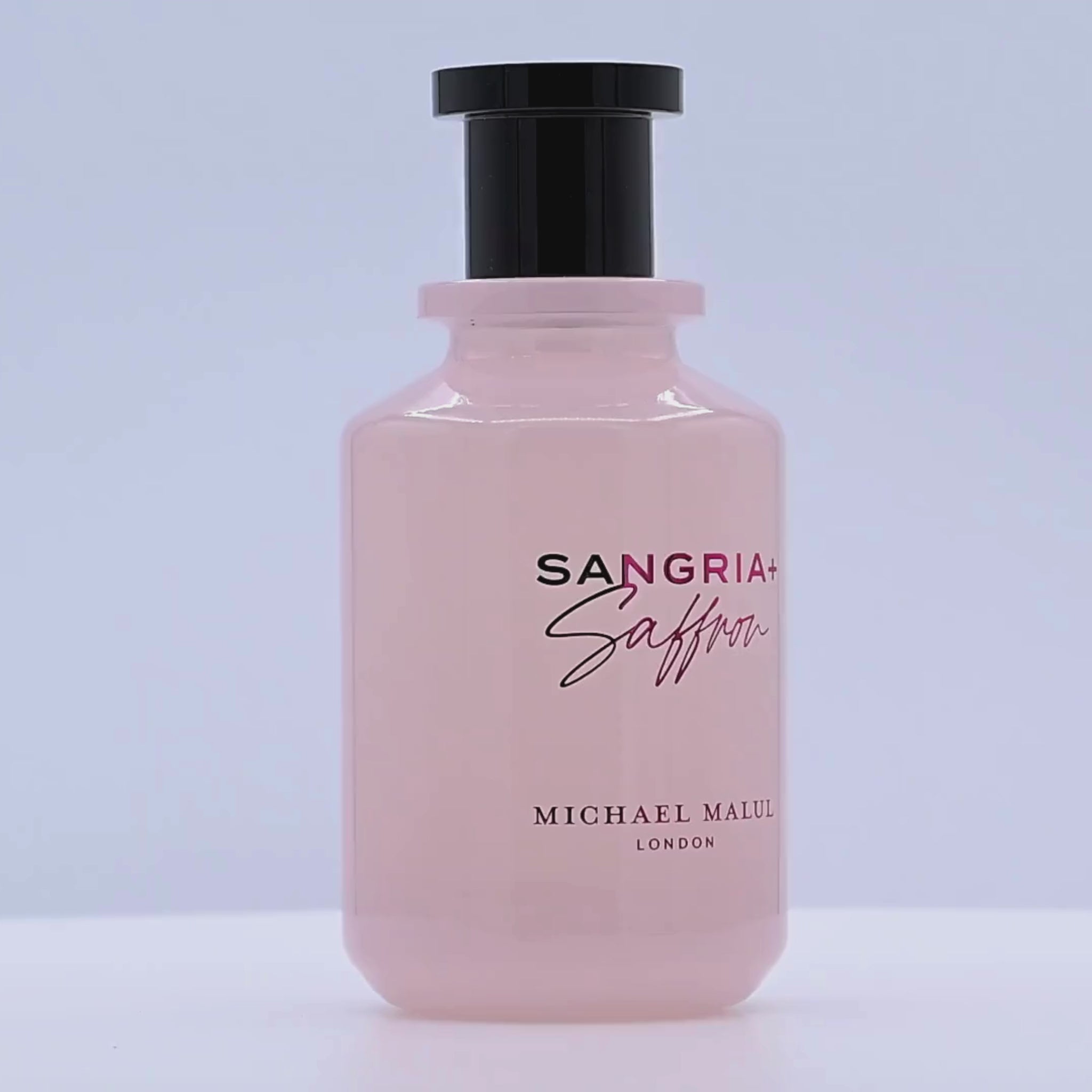 Sangria Saffron perfume bottle rotating on a white podium