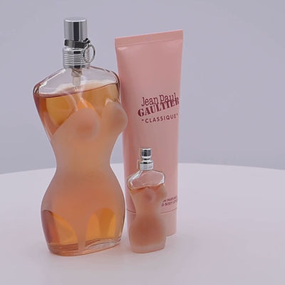 Perfume bottles rotating on a white podium
