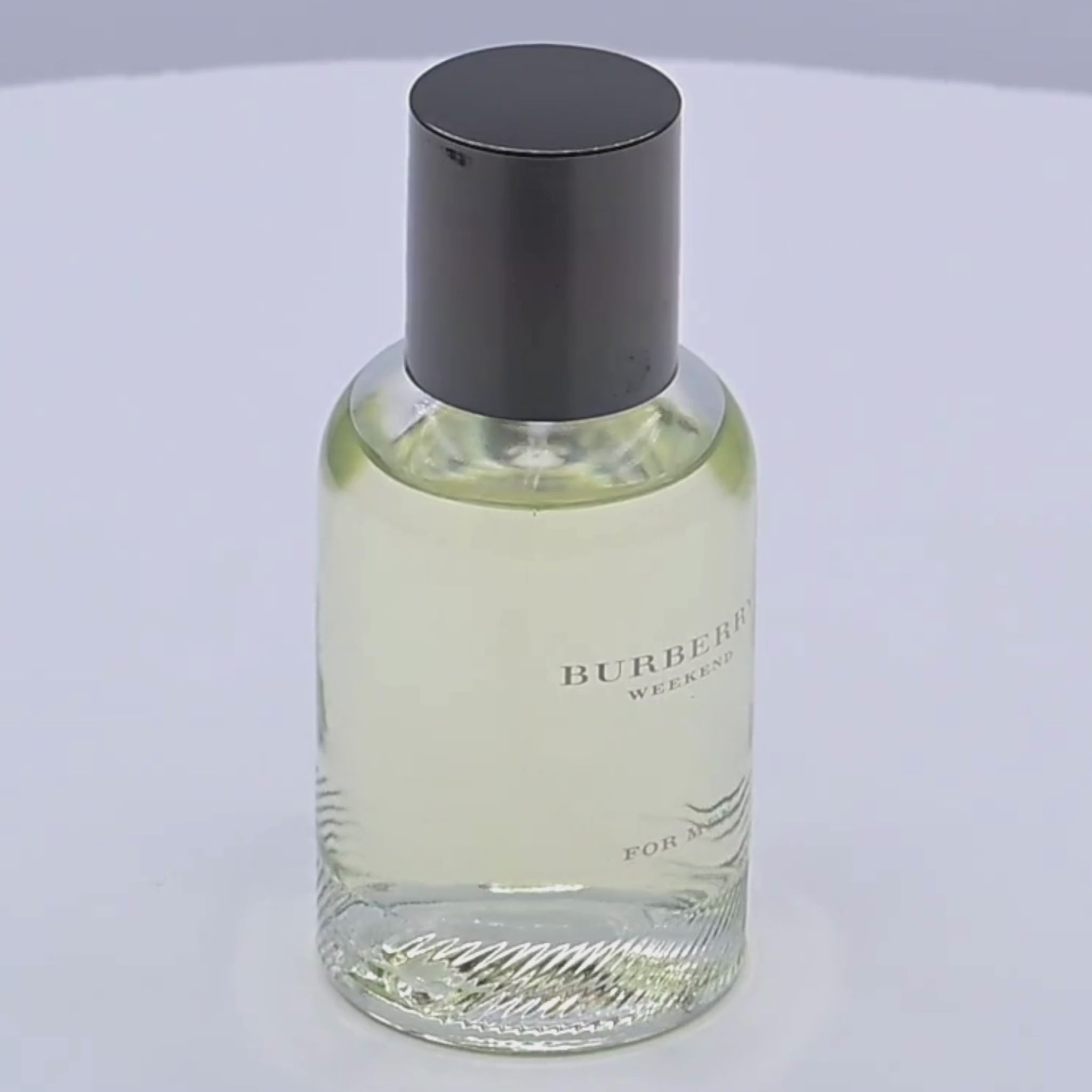 Burberry Weekend for men Eau de Toilette bottle rotating on a white podium