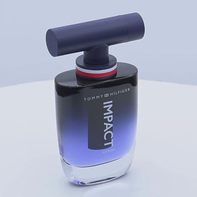 Tommy Hilfiger Impact perfume bottle rotating on a white podium