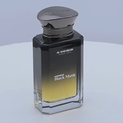 Al Haramain Black Musk perfume bottle rotating on a white background
