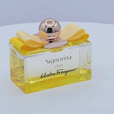 Salvatore Ferragamo Signorina Libera perfume bottle rotating on a white podium