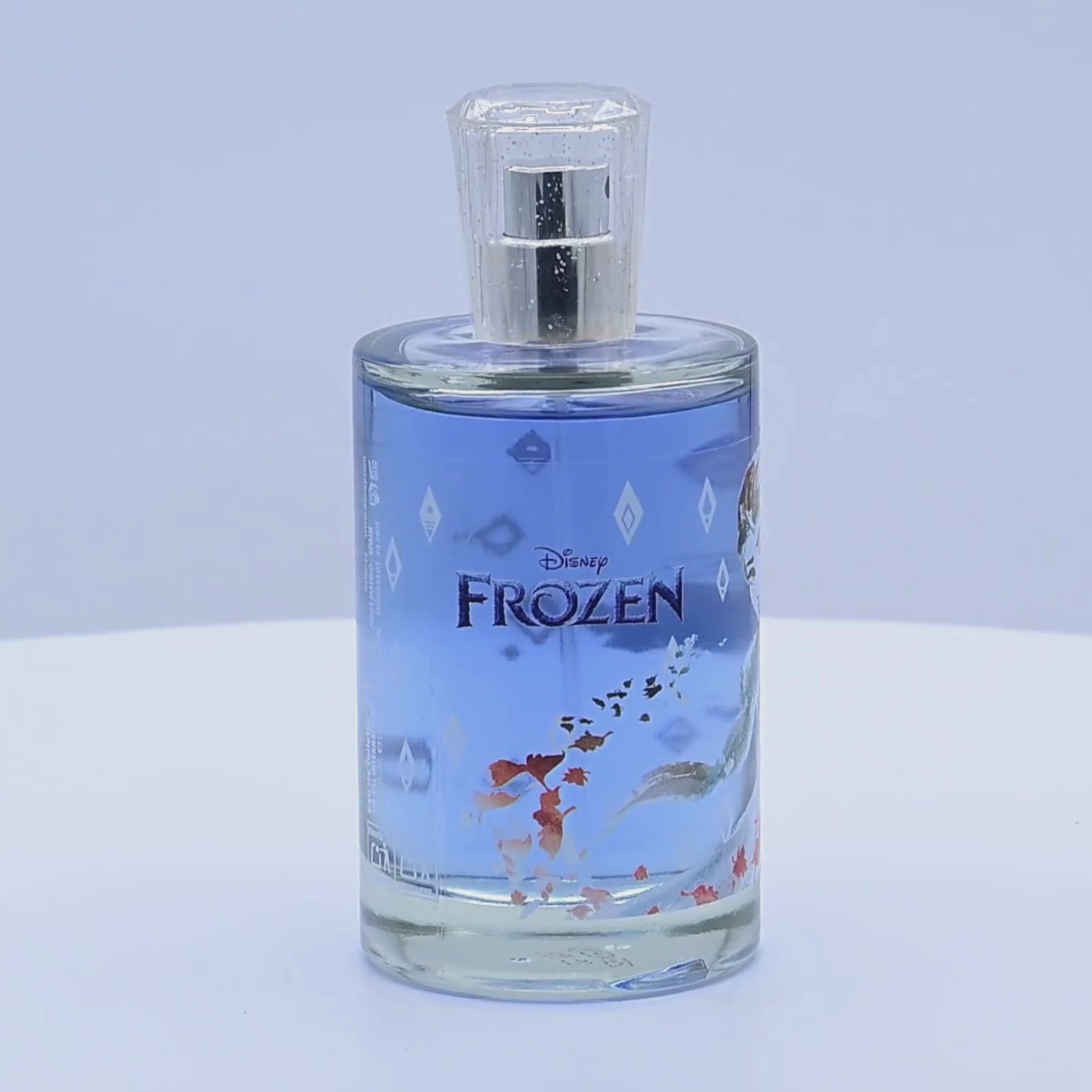 Disney Frozen perfume bottle rotating on a white podium
