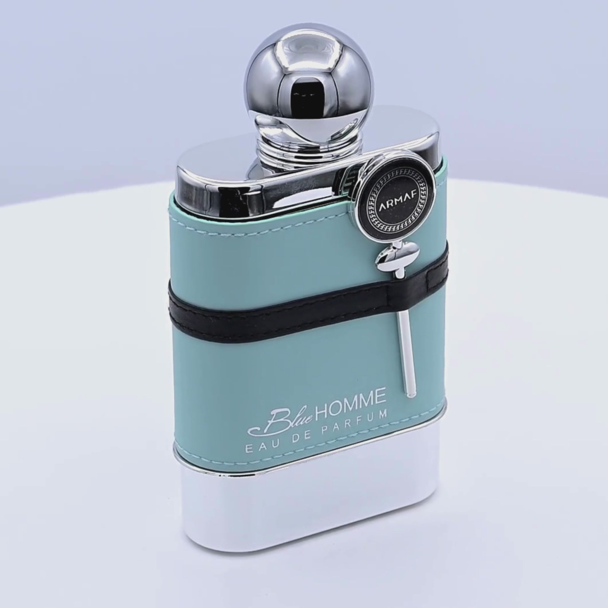 Armaf Blue Homme Eau de Parfum bottle rotating on a white podium