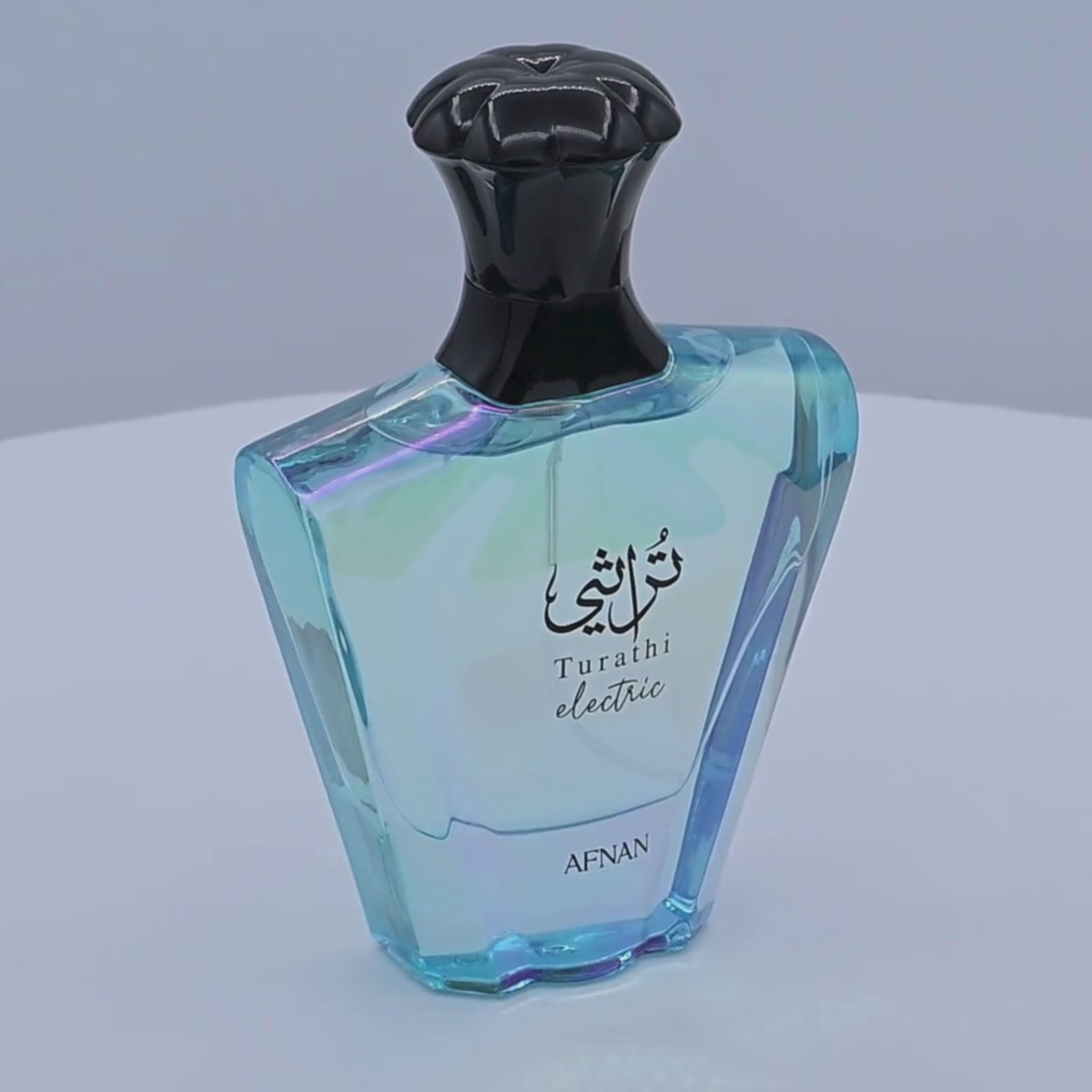 Afnan Turath electric perfume bottle rotating on a white podium