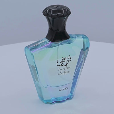 Afnan Turath electric perfume bottle rotating on a white podium